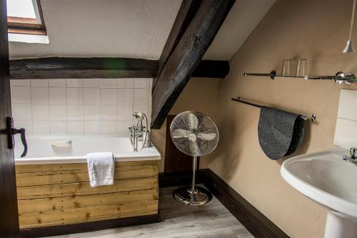 Bouth白鹿旅馆的带浴缸、水槽和风扇的浴室