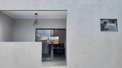 戈亚斯州上帕莱索Villa da Serra的开放式的客房拥有白色的墙壁和一张桌子。