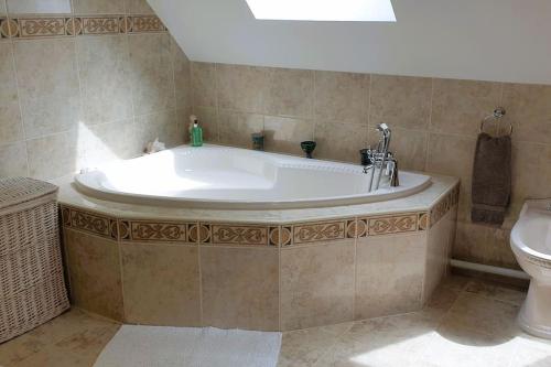 巴拉Cae Coryn Cottages, Snowdonia ( Troed y Graig )的一间带卫生间的浴室内的一个大浴缸