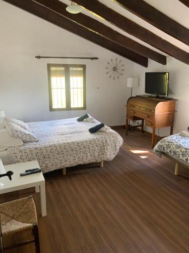 哈维亚VILLA MARETA的一间卧室配有两张床、一台电视和一张书桌