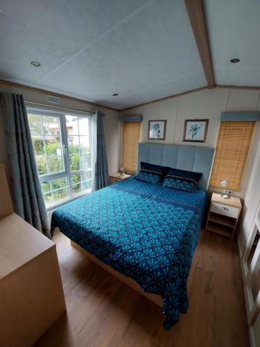阿旺桥Mobilhome - Kedidrouz du Léon - Kerlann - Pont Aven的一间卧室配有一张带蓝色床罩的床
