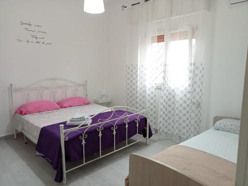 普罗斯西托角Casa Paky的一间白色卧室,配有两张床和窗户