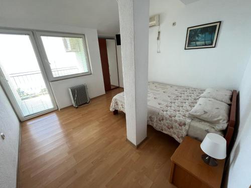 布雷拉Apartments Kricak的一间卧室设有一张床和两个大窗户
