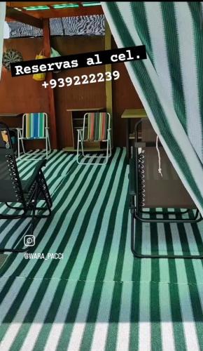阿里卡Villa frontera home的一间铺有绿色和白色条纹地毯的客房