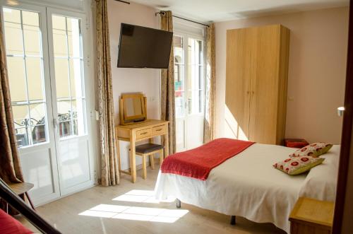哈卡哈克斯酒店的一间卧室设有一张床、一台电视和一个窗口。
