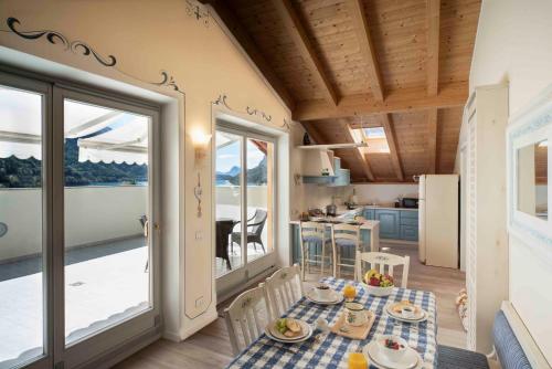 莫尔韦诺Attico con vista sul lago e montagne a Molveno的配有桌椅和厨房的房间