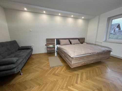 VisokoMici's Apartments的一间卧室配有一张大床和一张沙发