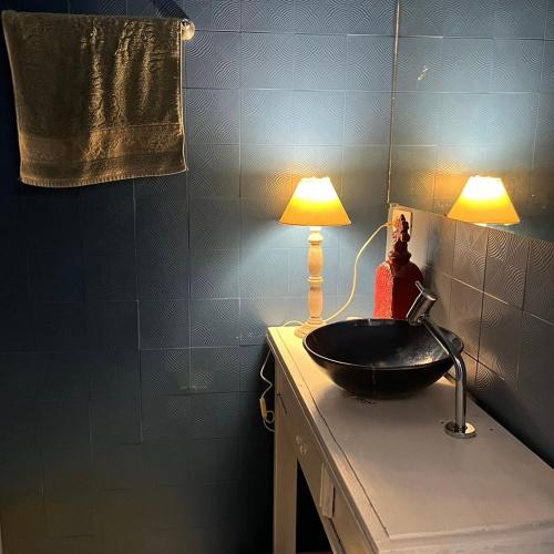 库里提巴Espaço Azul的浴室设有水槽和台面上的灯