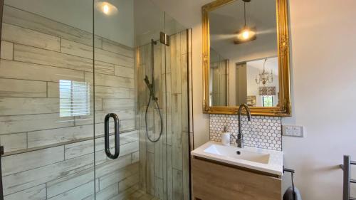 Ohau基林谷仓住宿加早餐旅馆的带淋浴、盥洗盆和镜子的浴室