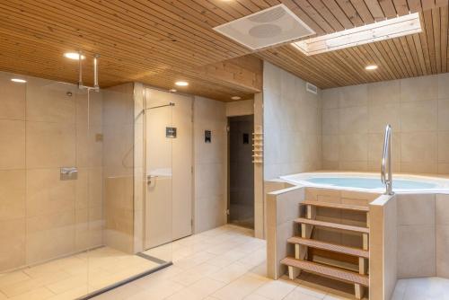 埃克斯鲁Fletcher Familiehotel De Hunzebergen的大型浴室设有浴缸和淋浴。
