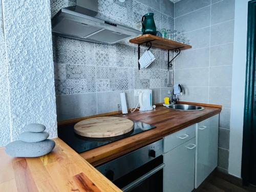 洛斯雷亚莱霍斯Sea lover's nest的一个带木台面和水槽的小厨房