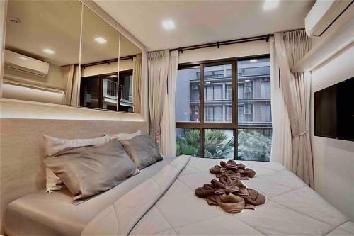 华欣Huahin Stay的一间卧室设有一张大床和大窗户