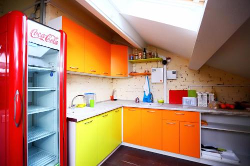 顿河畔罗斯托夫顿河畔罗斯托夫ID旅舍的厨房配有橙色和黄色橱柜以及古柯冰箱