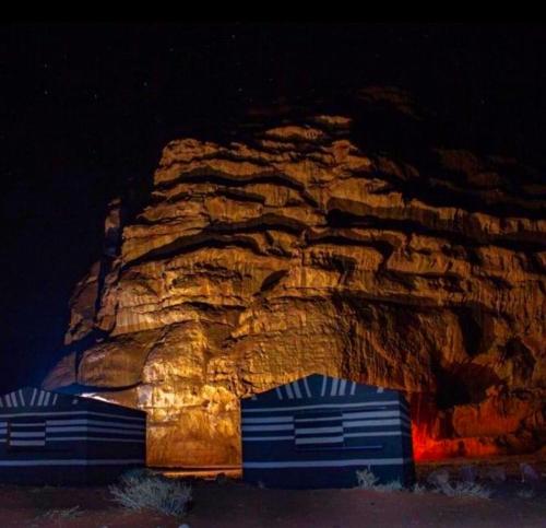 瓦迪拉姆Wadi Rum Meteor camp的岩石前的两辆蓝色拖车