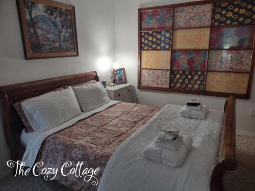 MiramonteCozy Cottage的一间卧室配有一张床,上面有两条毛巾