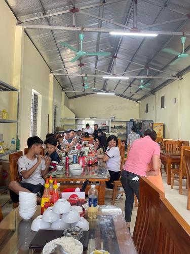 宁平Khách Sạn Hà Phương的一群坐在厨房桌子上的人