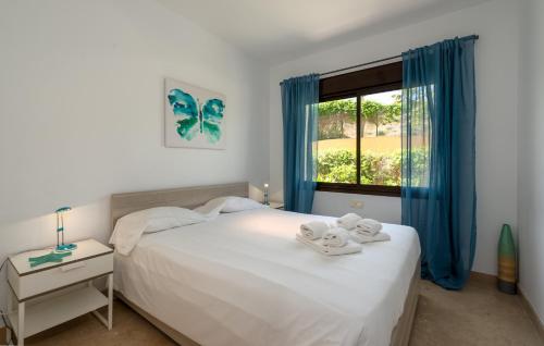 阿尔加德萨2149-Amazing groundfloor 3 bedrooms on golf, pools的一间卧室配有床和蓝色窗帘的窗户
