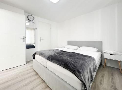 卡尔斯鲁厄Schickes Apartment in City Lage B7的白色卧室设有一张大床和镜子
