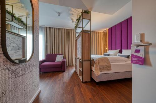 灵斯海姆FourSide Hotel Ringsheim的酒店客房,配有床和镜子