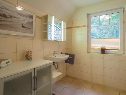 赛巴特班森Haus Auguste - App. 16的一间带水槽和卫生间的浴室以及窗户。