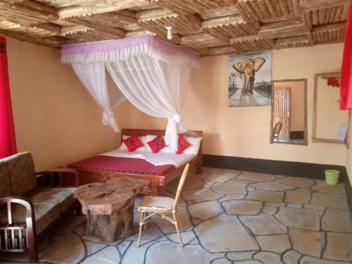 EmaliJambo Afrika Resort的客房设有床、沙发和桌子。
