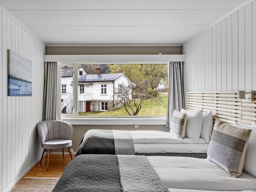 艾菲约德Eidfjord Hotel的一间卧室设有两张床和大窗户
