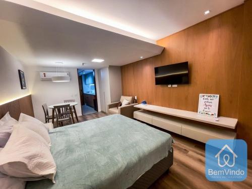 萨尔瓦多Apartamento completo com píer e acesso ao mar 4的一间卧室配有一张床、一台电视和一张桌子