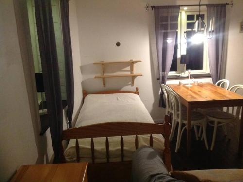 韦姆达伦Mysig liten stuga i Vemdalen的客房设有床、桌子和窗户。