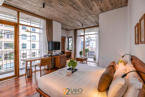 河内22Land Hotel & Residence的一间卧室配有一张床和一张书桌及电视