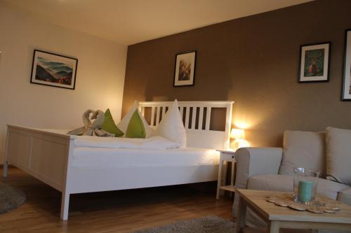 施卢赫湖Ferienhaus Carl的卧室配有一张白色的大床和一张沙发。