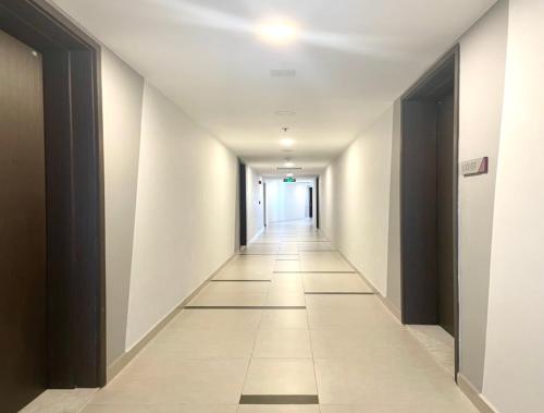 Ấp Phú ThọCompass One Building - Luxury Apartments的一条有白色墙壁和长走廊的走廊