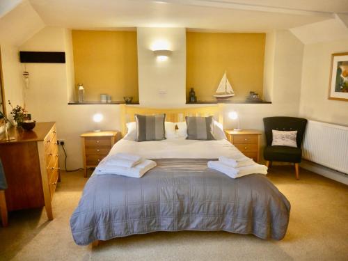 西卢港Talehay Cottages的一间卧室配有一张大床和一把椅子