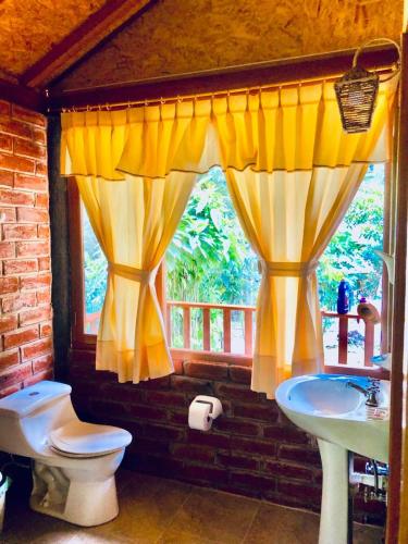 巴尼奥斯Munay Wasi的一间带卫生间、水槽和窗户的浴室