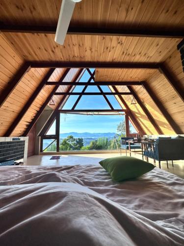KadugannawaThe Cloud Resort的一张位于带大窗户的房间内的床铺