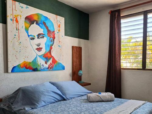 坎昆Tu Casa en el Caribe的卧室墙上有一幅女人画
