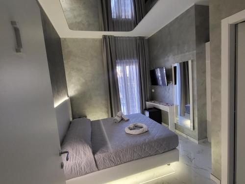 ApricenaB&B Luxury Room & SPA的一间卧室,配有一张床,上面有帽子