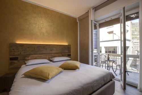 奥斯塔LA LUPA Appartment- In the heart of Aosta with car Box - CIR Aosta 0009的一间带大床的卧室和一个阳台
