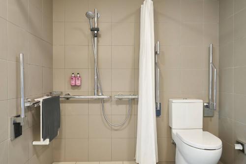 伦敦伦敦斯特拉特福德慕奇夕酒店的带淋浴、卫生间和浴帘的浴室