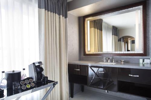 塔尔萨塔尔萨品牌吉臣酒店的一间带水槽和镜子的浴室