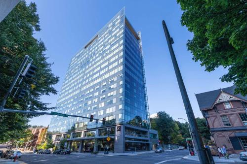 波特兰Hotel Vance, Portland, a Tribute Portfolio Hotel的城市街道上一座高大的建筑,有交通灯