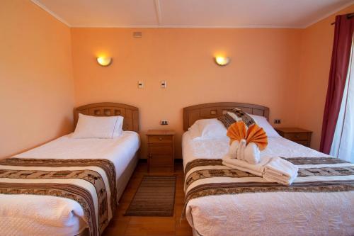 圣佩德罗·德·阿塔卡马Inti & Killa Hostal的一间卧室配有两张带毛巾的床