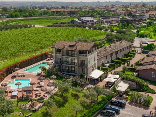 佩斯基耶拉德加达Bertoletta Village Apartments的享有带游泳池和庭院的房屋的空中景致