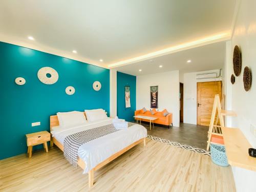邦劳Holabay Resort的一间卧室设有一张大床和蓝色的墙壁