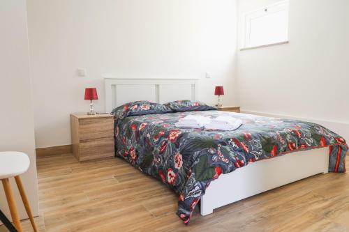 蓬德利马Casa Vilar R/C的一间卧室配有一张带花卉床罩的床