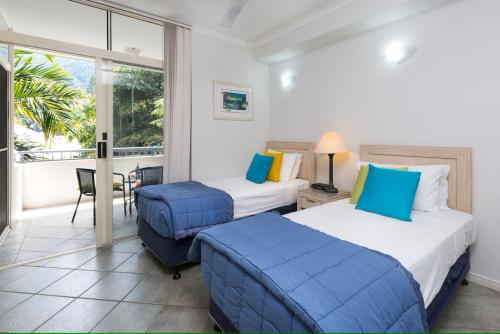 棕榈湾Oasis 8 at Palm Cove的酒店客房设有两张床和一个阳台。