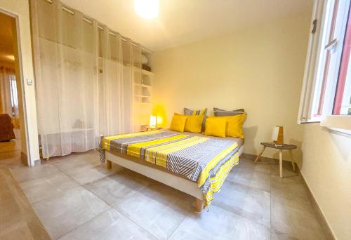 FilaosL'Hermitage - Appartement T3 en bord de plage的一间卧室配有一张带黄色枕头的床
