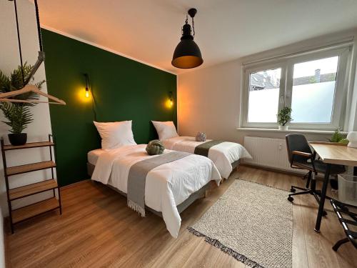 埃森Design Apt. Messe•HBF•Uniklinik的绿墙客房的两张床