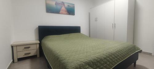 埃拉特Yona balev的一间卧室设有绿床和床头柜