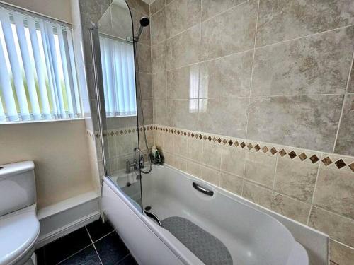 利物浦Baltic Gem 4 Bedroom Townhouse with free parking的带淋浴、浴缸和卫生间的浴室