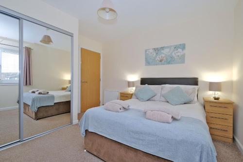 阿伯丁Caledonia Netherhills Apartment的一间卧室设有两张床和大镜子